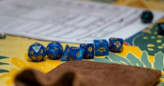 Dés de jeu de rôle posés devant une feuille de personnage